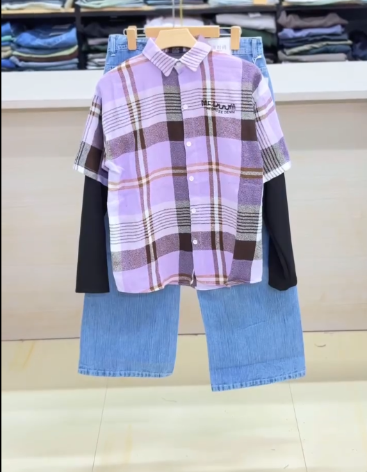 Effortless Layered Style: Casual Plaid Short-Sleeve Shirt Over Black Top with Light Blue Trousers