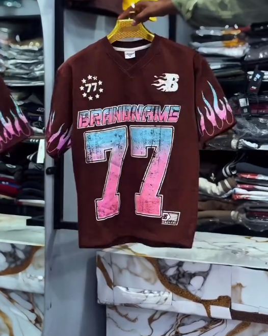 Bold Street Energy: Turquoise V-Neck Jersey with “77” Graphic and Pink Flame Accents