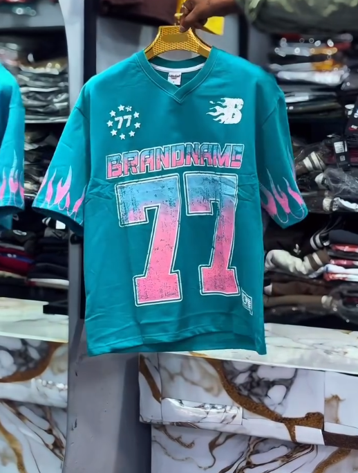 Bold Street Energy: Turquoise V-Neck Jersey with “77” Graphic and Pink Flame Accents