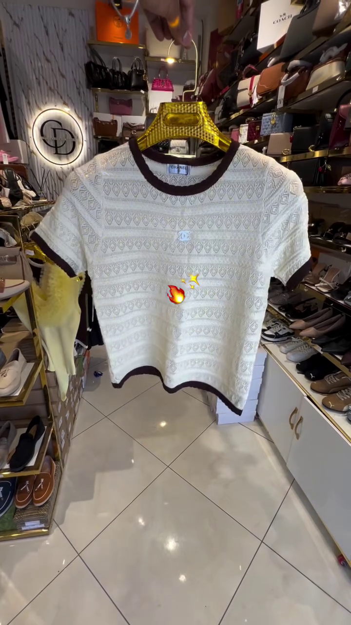 Chic Femininity: Pink Knit Top with Textured Pattern and Elegant White Trim