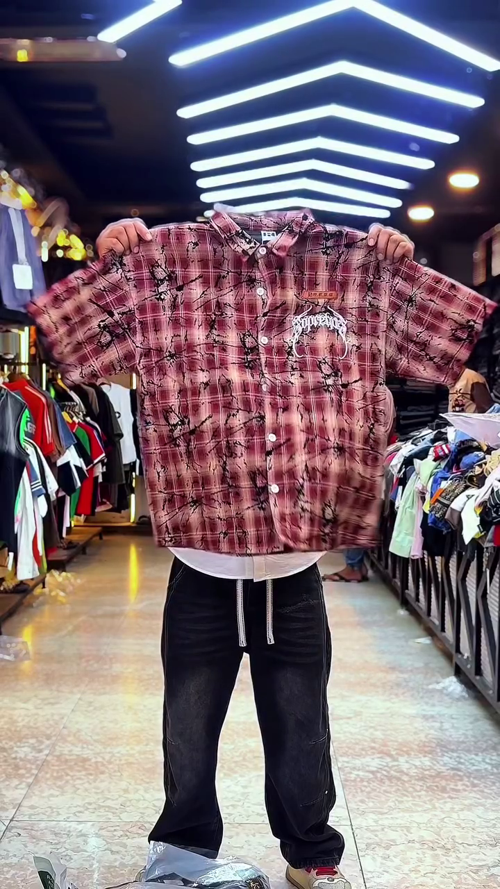 Edgy Street Casual: Red Plaid Checkered Shirt with Ink-Splatter & Graphic Branding