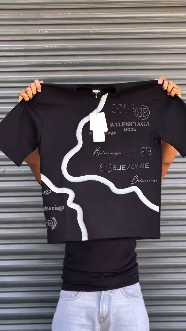 This Balenciaga t-shirt features a distinctive multi colour graphic print and various branded logos.