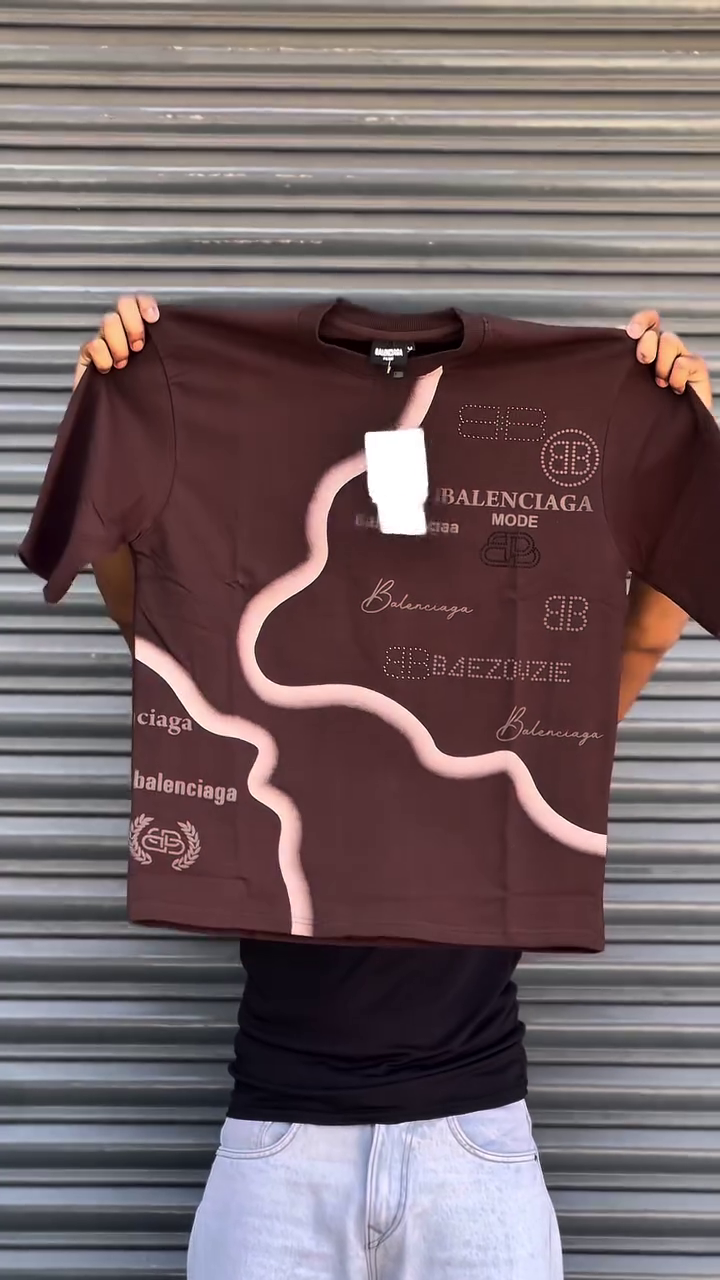 This Balenciaga t-shirt features a distinctive multi colour graphic print and various branded logos.
