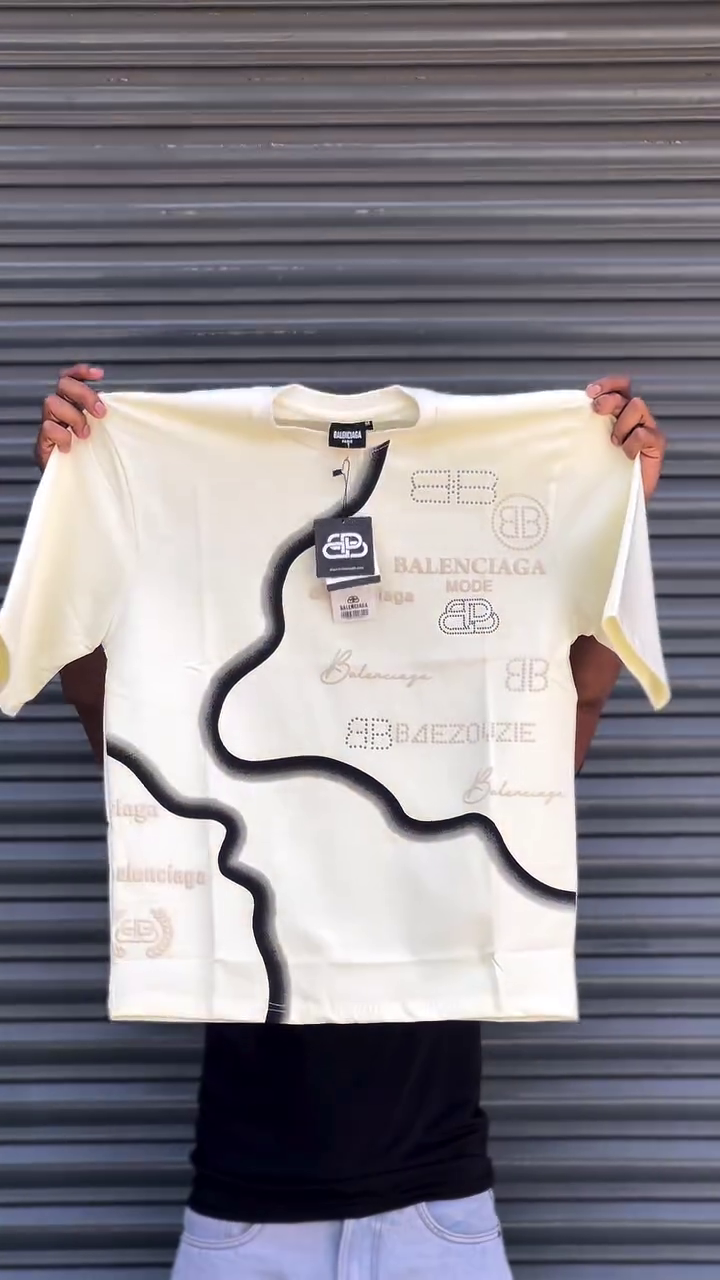 This Balenciaga t-shirt features a distinctive multi colour graphic print and various branded logos.