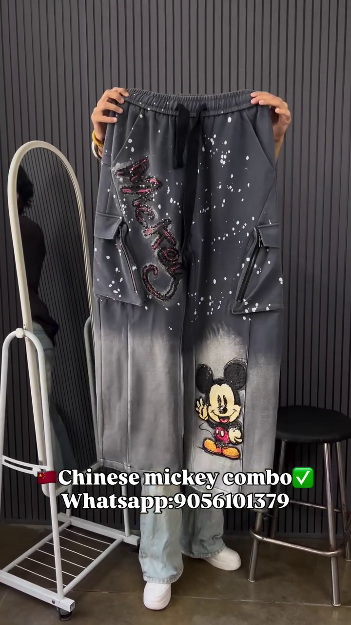 This image shows a black cotton oversized graphic t-shirt and trouser featuring multiple prints of the Disney character Minnie Mouse.