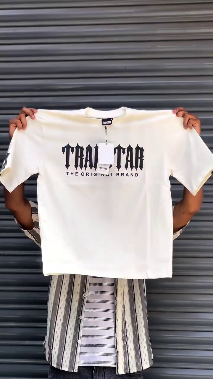 The product shown is a Trapstar multi colour  t-shirt featuring the brand's logo.