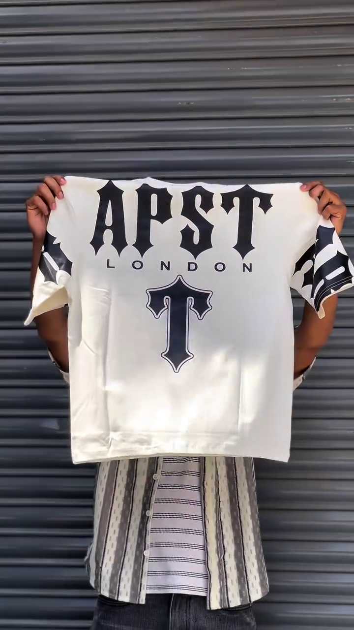 The product shown is a Trapstar multi colour  t-shirt featuring the brand's logo.