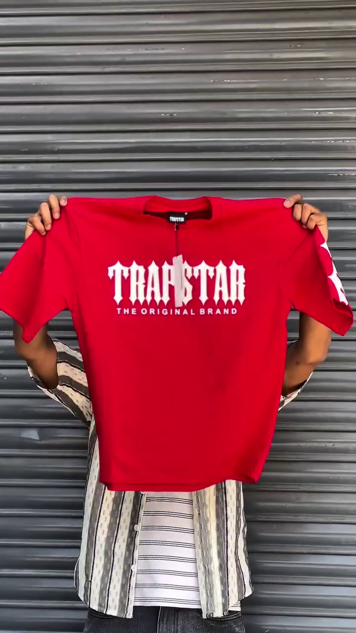 The product shown is a Trapstar multi colour  t-shirt featuring the brand's logo.